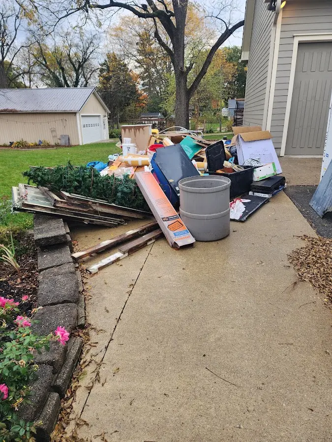 Dumpster being loaded with debris for Estate Cleanout Dumpster Rental in Penn Forest